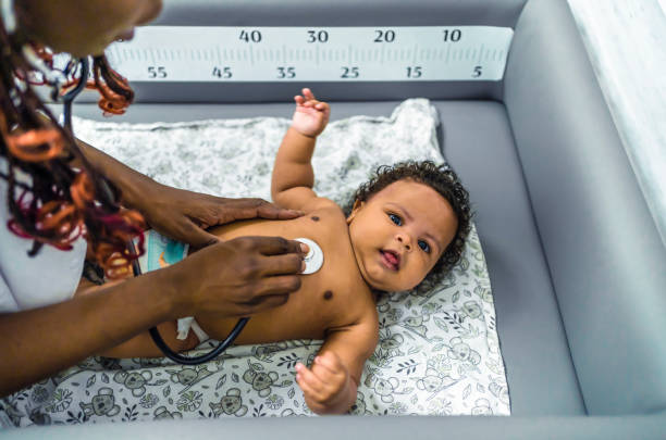 istock Pediatrician examining baby 1447771535