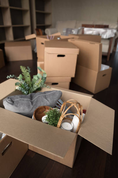 istock Vertical view stuffed with belongings cardboard boxes stacked on floor 1447771780