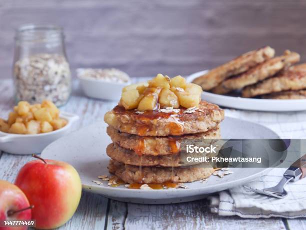 A Plate Of Healthy Rolled Oat And Apple Pancakes Topped With Cooked Diced Apple Stock Photo - Download Image Now
