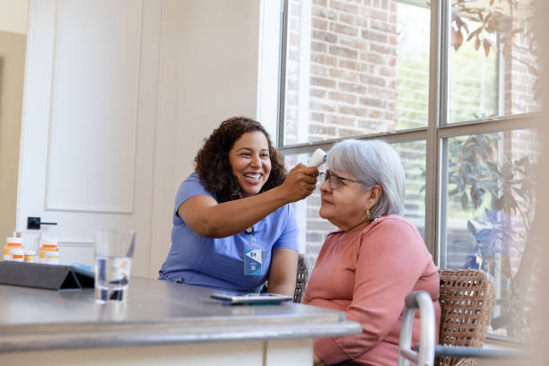 istock Home health nurse takes temperature 1447776658