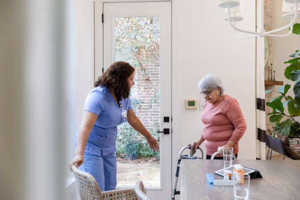 istock Home health nurse helps her elderly patient 1447776693