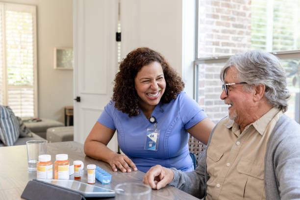 istock Female nurse enjoys visiting with her patient 1447776719