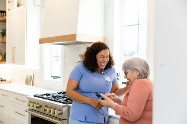 istock Senior woman smiles while talking to the nurse 1447776734