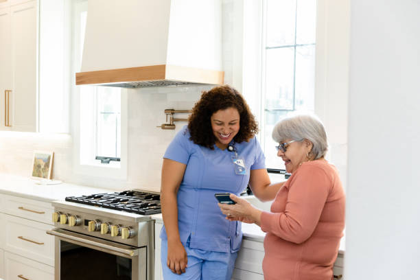 istock Hospice nurse smiles while looking at phone 1447776741