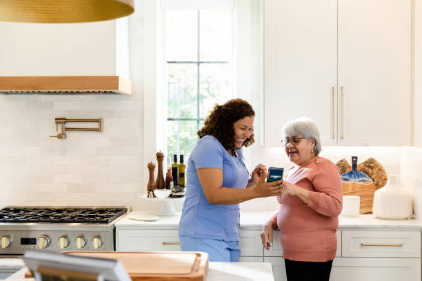istock Female nurse helps her elderly patient 1447776745