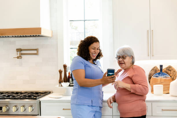 istock Female nurse helps elderly patient 1447776746