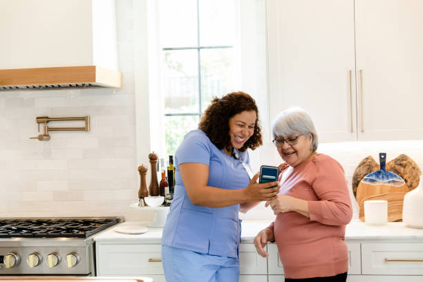 istock Visiting nurse takes selfie with senior patient in kitchen 1447777145