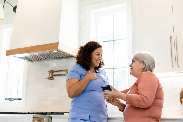 istock Senior patient and visiting nurse talk together in kitchen 1447777146