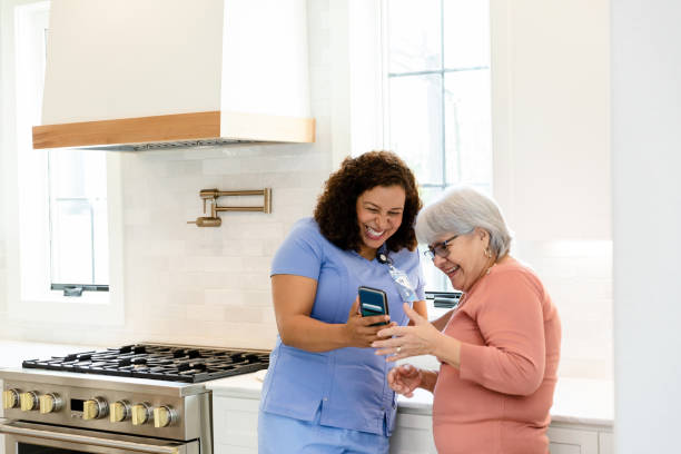 istock Senior patient and visiting nurse laugh when they see selfie 1447777150