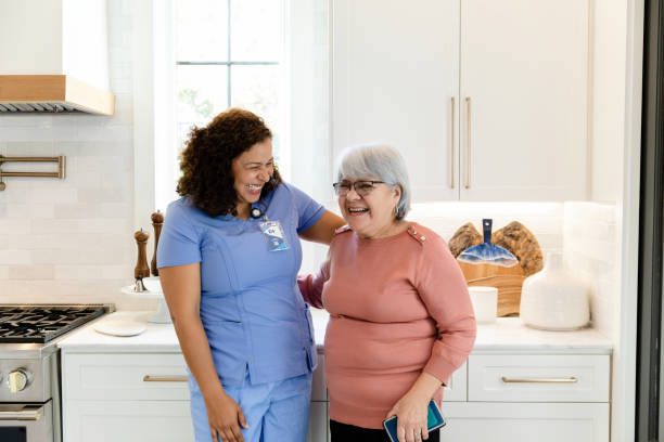 istock Visiting nurse enjoys being with senior female patient 1447777155