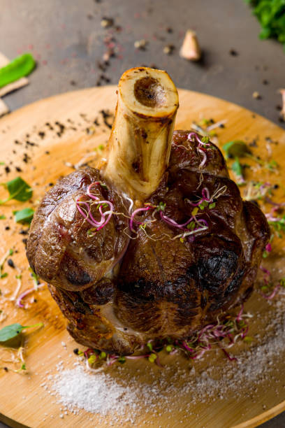 veal knuckle in Bavarian style on wooden board vertical