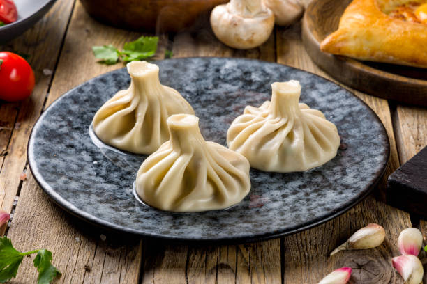istock Khinkali with lamb on beautiful plate on wooden table 1447780019