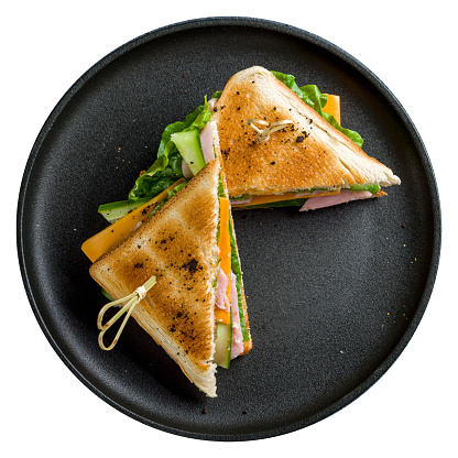 ham and cheese sandwich on black plate top view