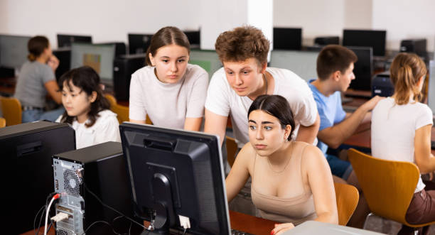 istock Portrait of multinational young students group  emotionally reacting while studying at  pc in  computer  class 1447782140