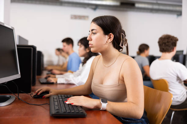 istock Concentrated Latin female student using PC and studying computer science in the classroom 1447782682