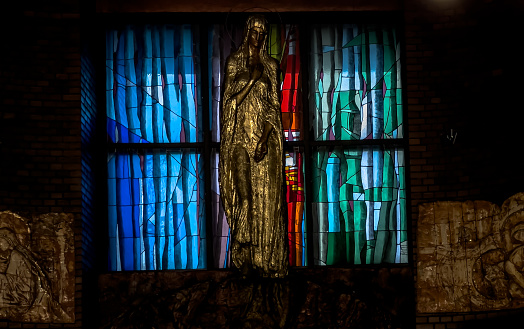 Tarnowskie Gory, Poland, November 19, 2022: Church of Our Lady Queen of Peace in Tarnowskie Góry. The figure of Mary against the background of a stained glass window