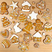 A set of gingerbread cookies of different shapes, on a wooden table.