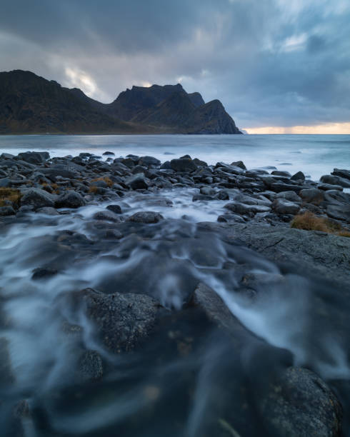 istock Small river flowing at Unstad beach, Lofoten Islands, Norway 1447789933