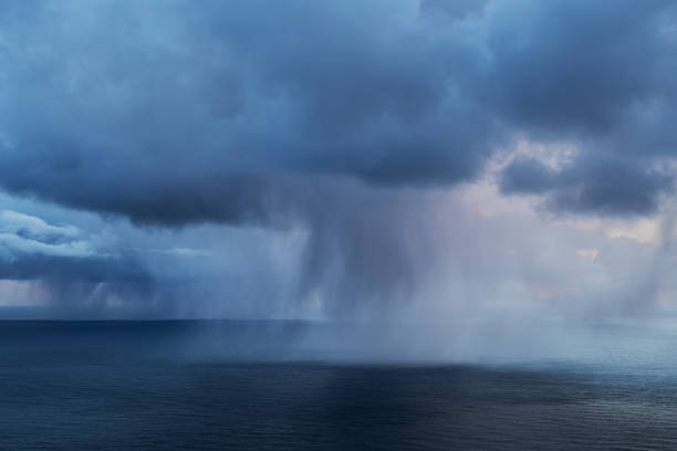 Spring snow flurries fall over sea, Lofoten Islands, Norway in Fredvang, Nordland, Norway