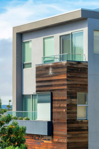 istock House facade with wooden frame and moddern beige stucco house frame with windows and flat roof 1447790891