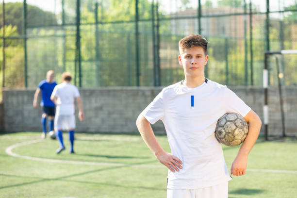 istock Junior football player on field 1447791960