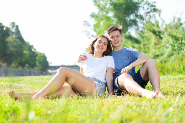 istock Guy and girl resting in the park 1447791983