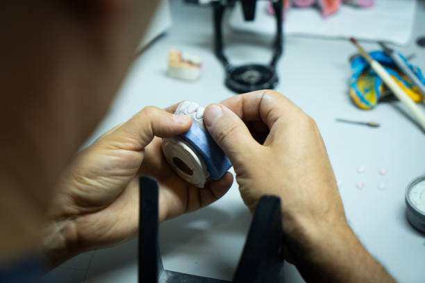 istock dental technician creates dental prostheses. laboratory. close-up. 1447796575