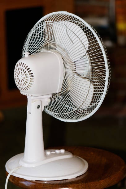 istock White Electric Fan Sitting On Stool From Back 1447797912