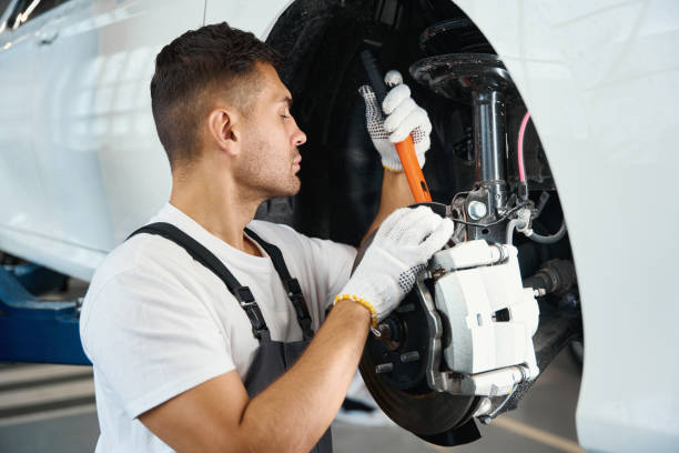 istock Man removing old wheel from car in tire fitting 1447802642