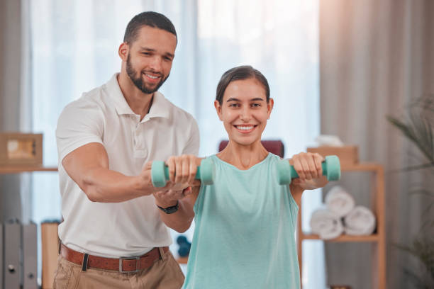 istock Fitness, personal trainer and woman with weights in home doing exercise, workout and training in living room. Health, wellness and female with male instructor doing weightlifting with dumbbells 1447803664
