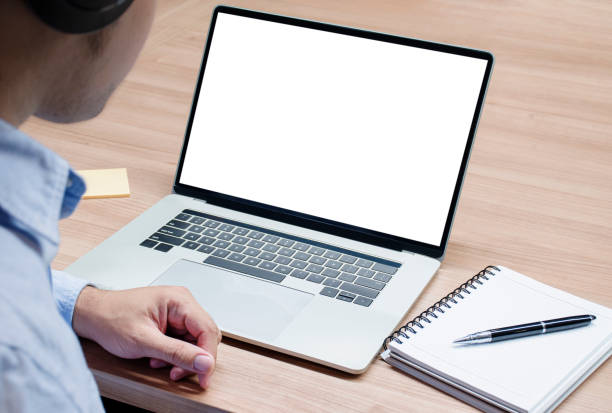 istock Businessman with headphone and white screen background mock up on display laptop with clipping path 1447810668
