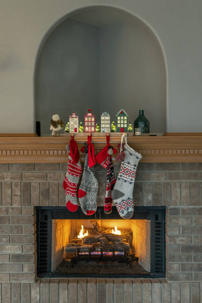 istock Christmas stockings hanging on fireplace hearth 1447810863