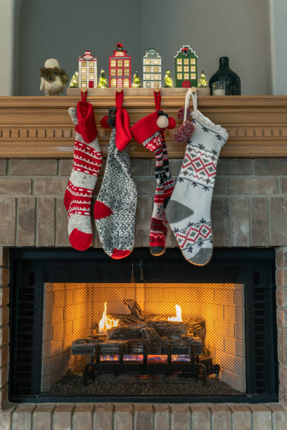 istock Christmas stockings hanging on fireplace hearth 1447810870