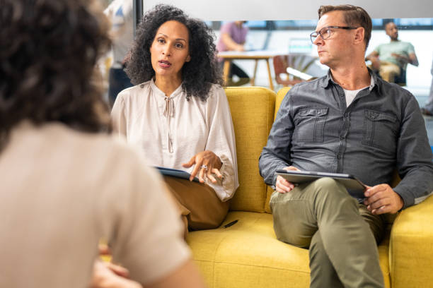 istock Hispanic businesswoman having interview and using hand gestures with Hispanic coworker to be. 1447812867