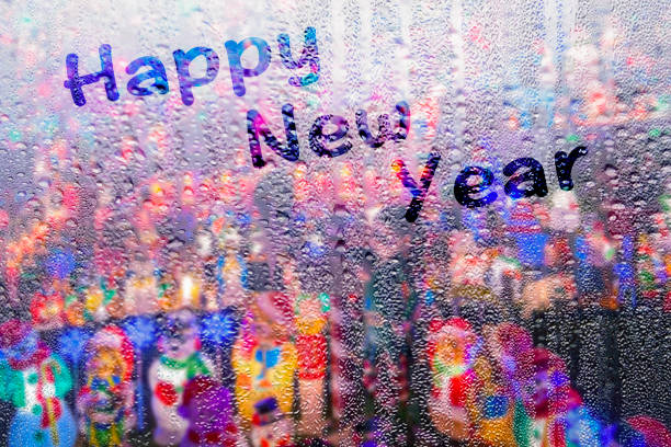 Happy New Year words on a rainy windowpane