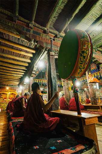 Thiksey, India - September 4, 2011: Tibetan Buddhist monks during prayer in Thiksey gompa (Buddhist monastery) of the Yellow Hat (Gelugpa) sect - the largest gompa in central Ladakh