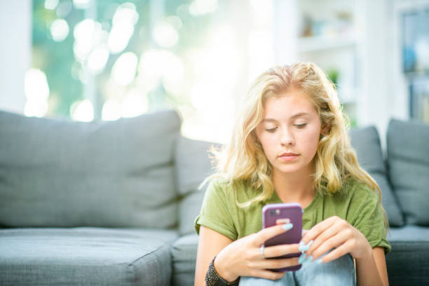 istock Teen on Her Cell Phone 1447818927