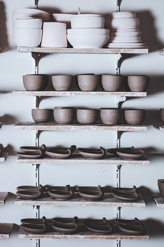 Clay Pots On Shelf Waiting For Decoration In Ceramics Studio