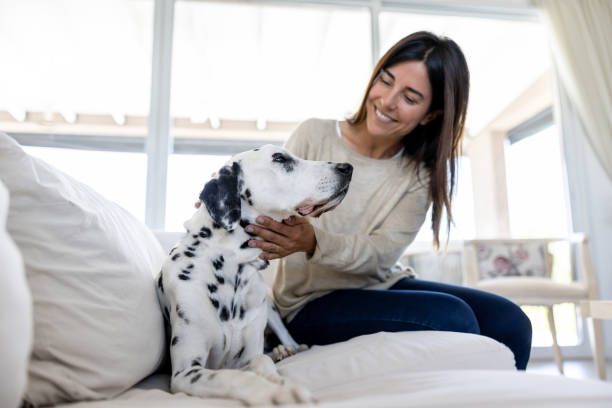 Happy woman at home pampering her dog