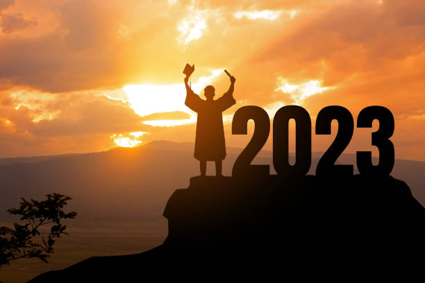 silhouette young man graduation in 2023 years, education congratulation concept, freedom and happy new year, success in the future goal and passing time.copy space. - announcement message fotos imagens e fotografias de stock