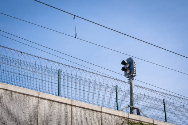 istock electric train energy cables and traffic light. razor safety mesh wires. 1447832386