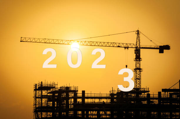 istock new year 2023 with construction crane. 1447837506