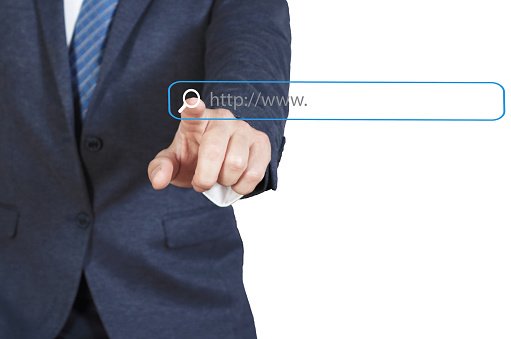 Businessman Touching Magnifier Icon In Search Box on virtual screen , Internet technology concept