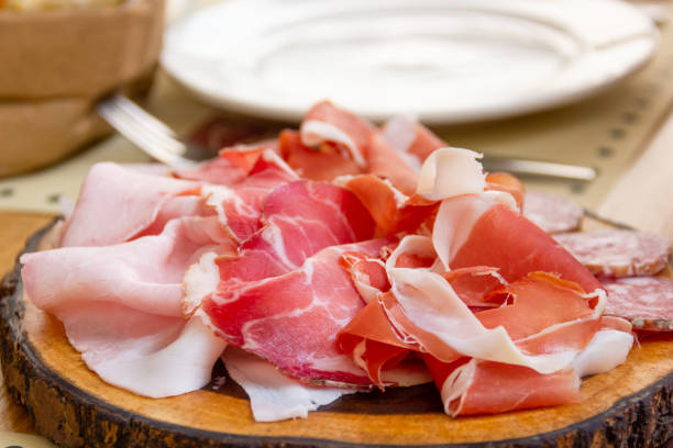 istock Smoked ham and prosciutto tapas on wooden board 1447840554
