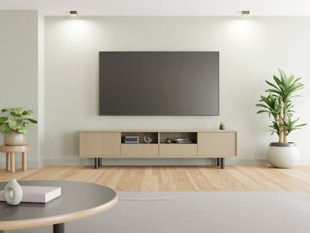 istock 3D rendering of modern living room with TV screen on white wall. 1447842398