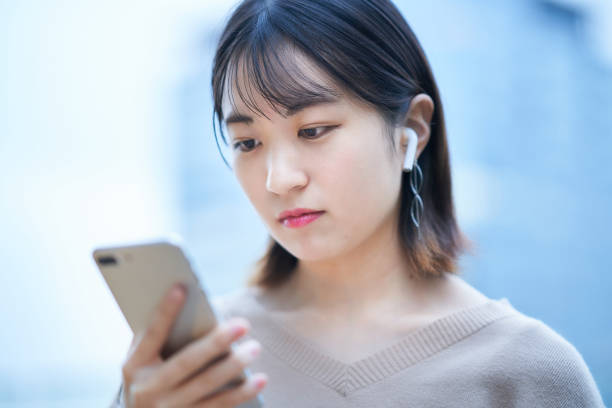 istock young woman looking at smartphone 1447844012