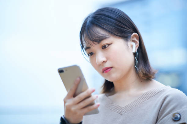 istock young woman looking at smartphone 1447844046