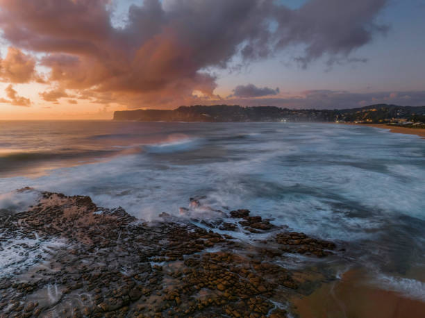 istock Surfs up sunrise at the seaside with scattered clouds 1447844288