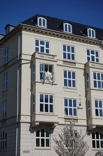 Copenhagen, Denmark – July 16, 2022: A sunny view of a residential building in Copenhagen against blue sky background