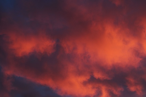 Colorful clouds above a sunset. Rich orange, red, blue, yellow and purple, clouds.